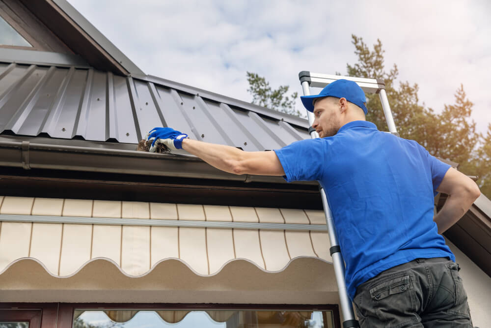 Vinyl gutters being installed | Calgary home spring gutter replacement project